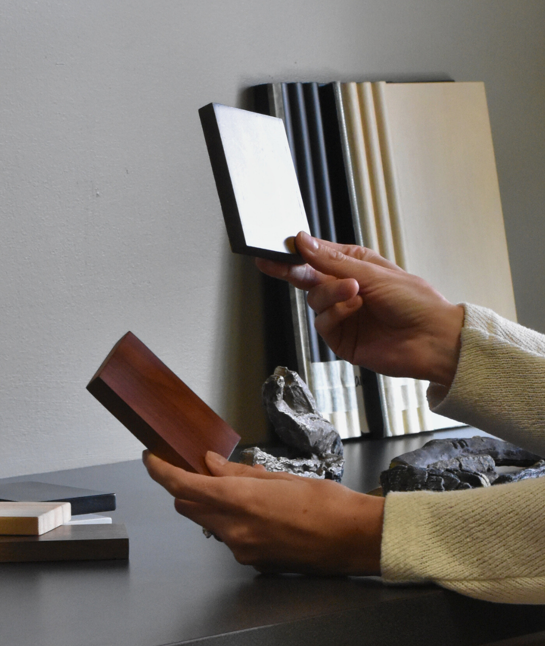 Designer selecting wood and finish samples for a custom Modern Ember fireplace project