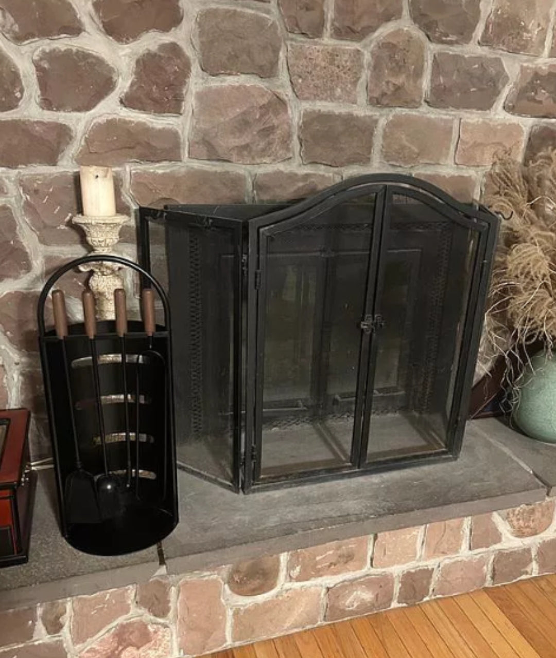 customer image of traditional hearth with arched black fireplace screen and matte black fire tool set with wooden handles.