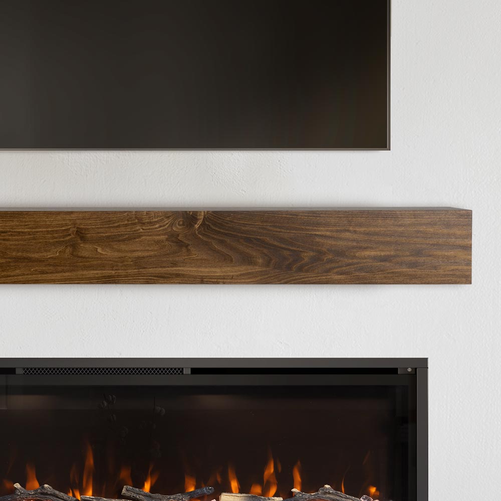 Boone 72-in Wood Mantel Shelf in Provincial Stain above a fireplace with flames