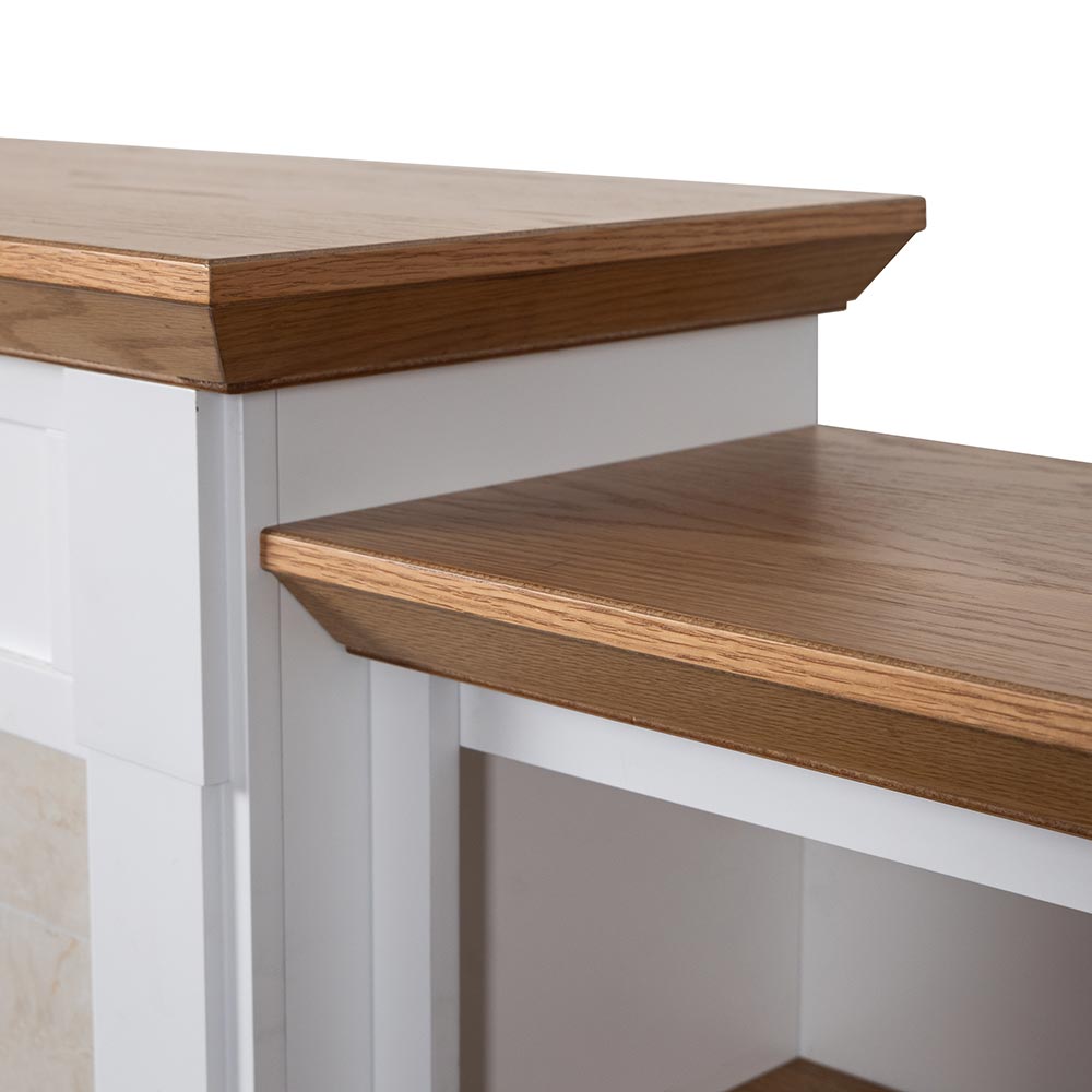 Close-up of the warm walnut mantel top and the clean white finish of the bookcase side.