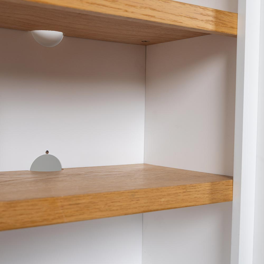Close-up of an individual shelf within the Belhaven Bookcase, showing the wood finish.