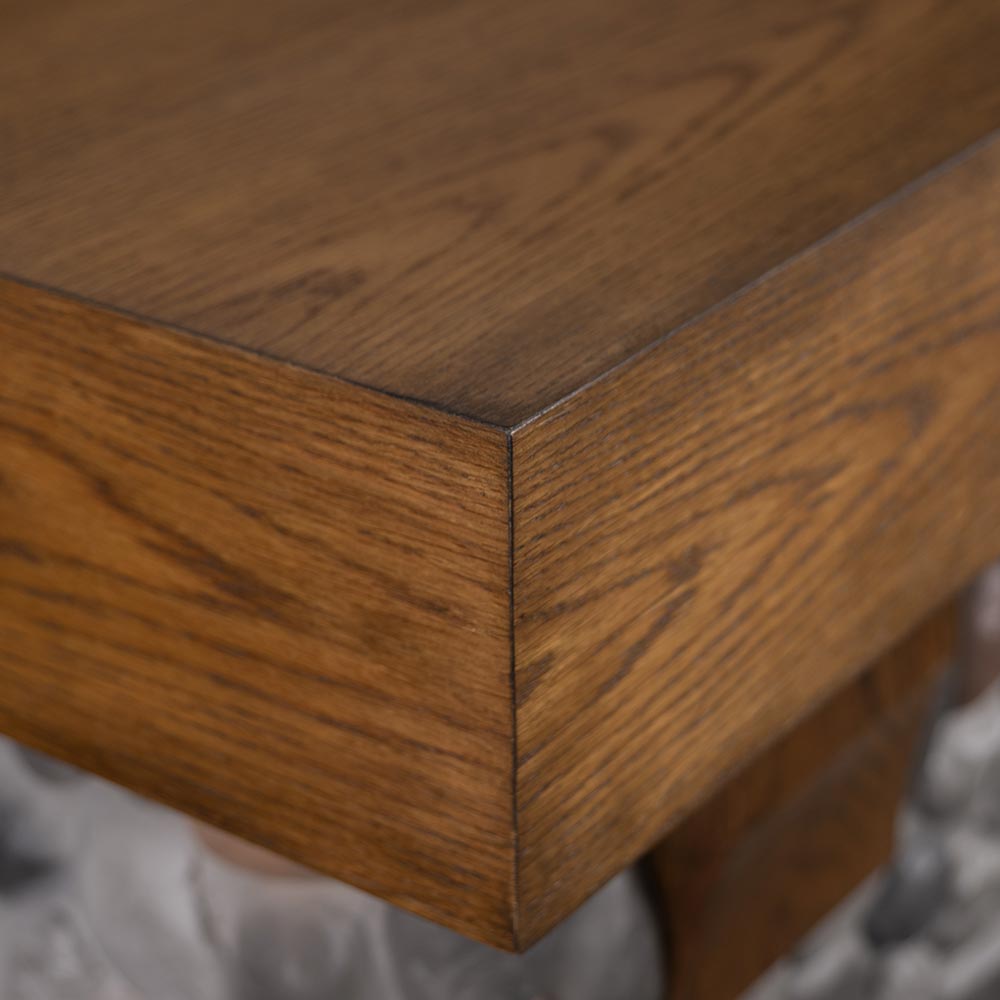 Close-up of the side profile of the white oak mantel shelf, showing its box construction.