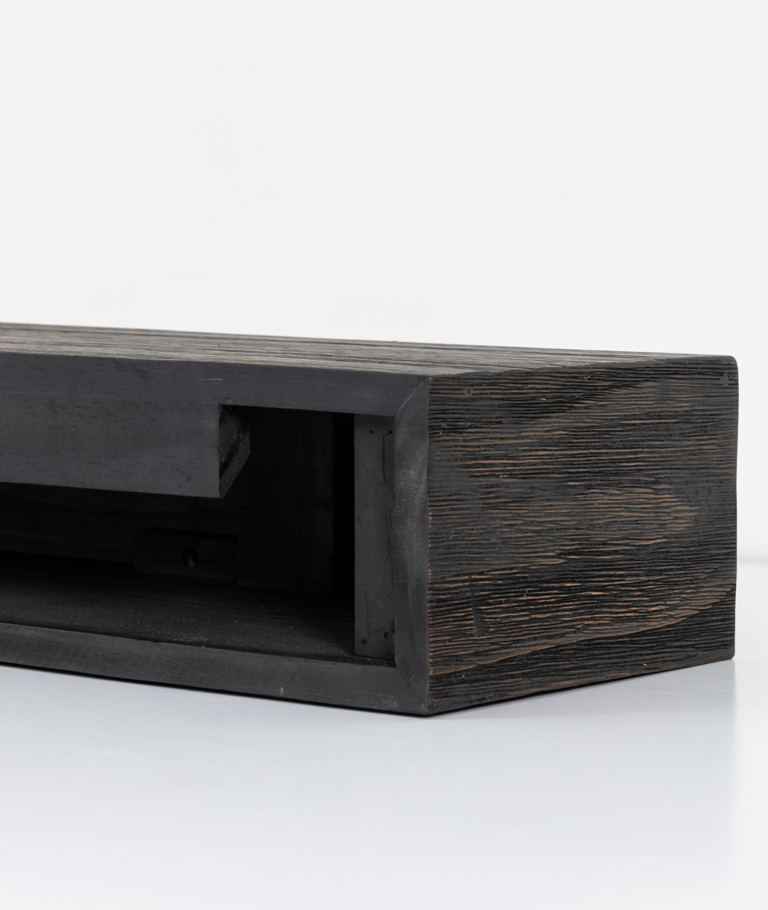 Close-up of dark-stained wooden mantelpiece with minimalist hollow-core design, showcasing Modern Ember’s easy-to-install fireplace surround—perfect for effortless setup and modern style.