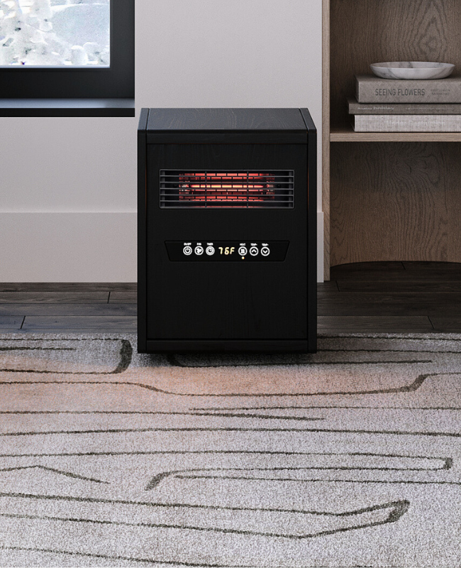 Compact black electric space heater by Modern Ember with digital controls and infrared heating element, placed in a modern living room with soft neutral decor and winter light.