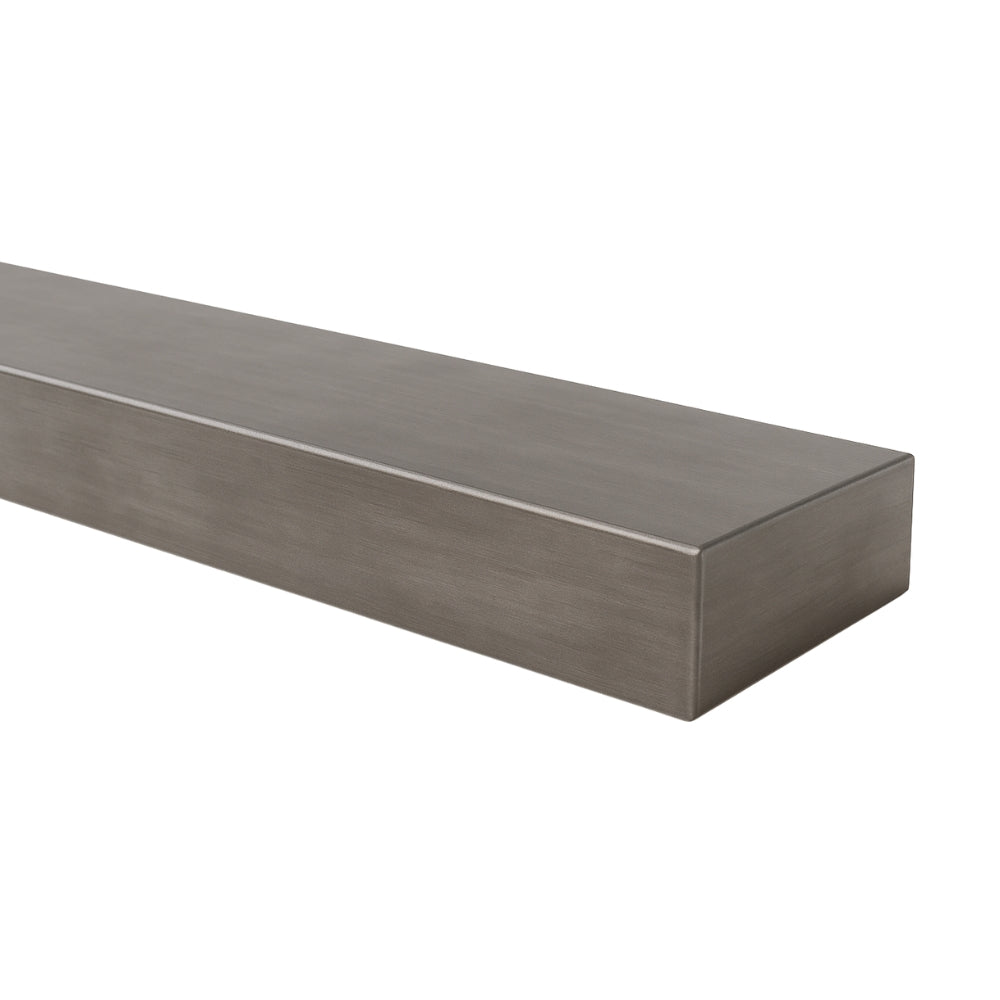 Angled view of the Lustra Metal floating shelf in a forged iron finish, emphasizing the clean, minimalist lines and light metallic tone.