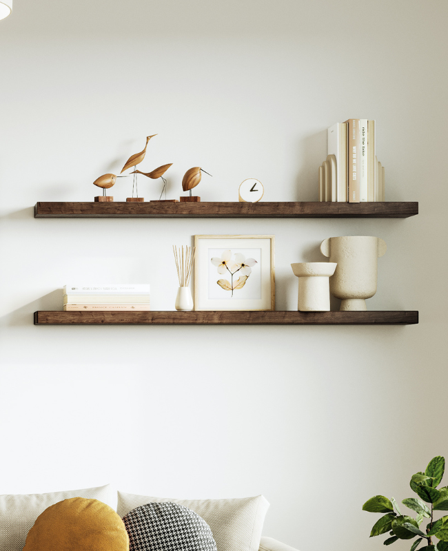 Two wooden floating shelves mounted on white wall with neutral modern decor