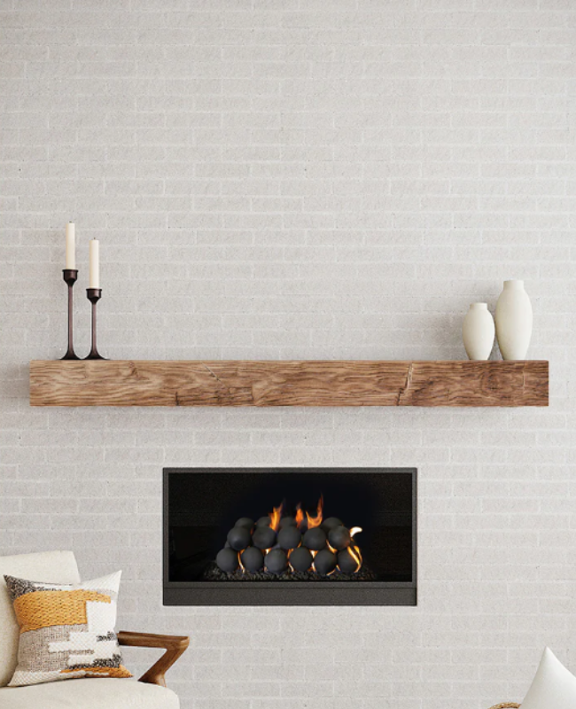 Fire-rated non-combustible mantel above recessed gas fireplace with flame-resistant stone facade