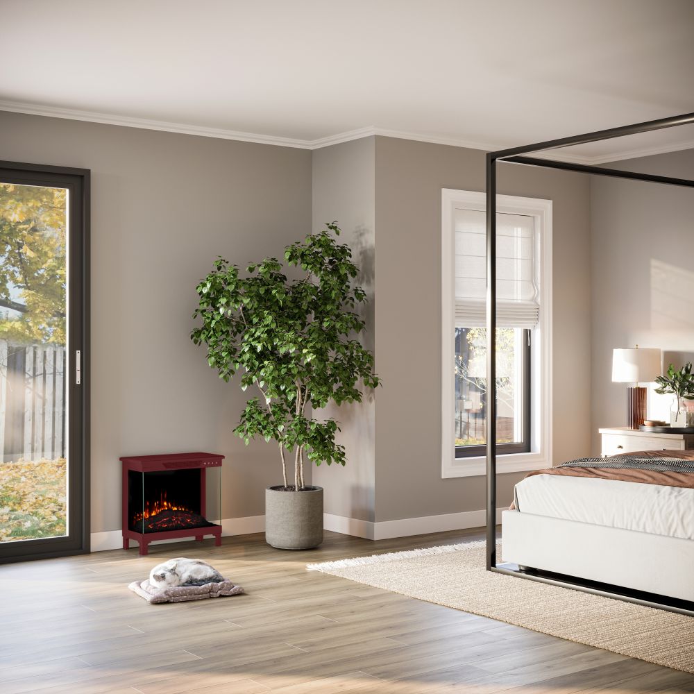 Cozy modern bedroom with the Skyline 3-Sided Electric Stove, red in the corner, providing zone heating up to 400 sq. ft.