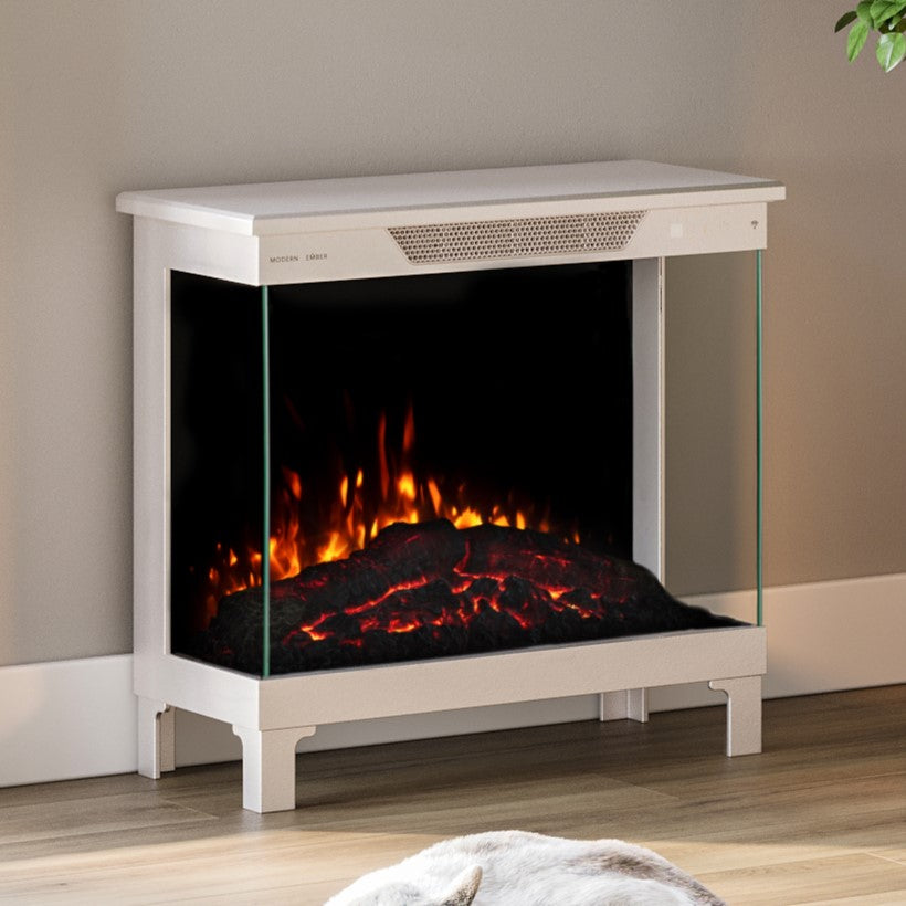 In-Context) Skyline Smart Electric Stove in a white finish, placed by a window, demonstrating its portability and freestanding design