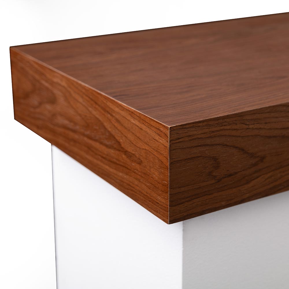 Close-up of the burnished walnut mantel top, emphasizing the wood grain and finish.