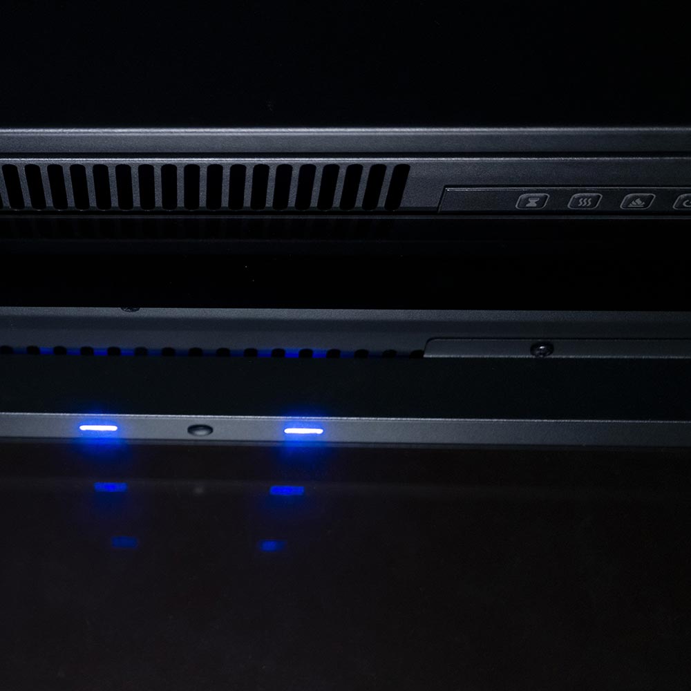 Close-up of the top interior of the 33" firebox insert, showing the downlight feature and heat vent.