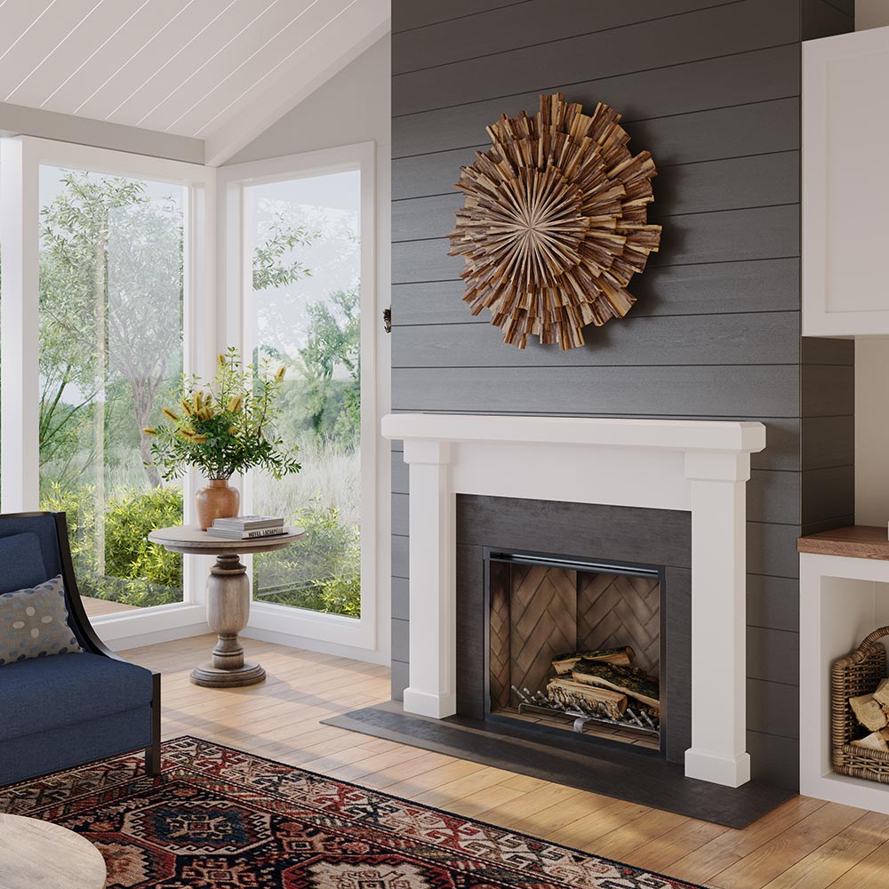 angle view of Modern Ember Nobel Mantel Surround in white painted finish with black firebox, styled in sunlit living room with large windows and neutral décor.