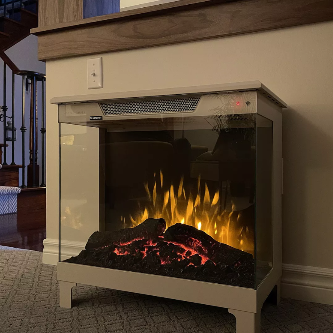 customer image of Modern Ember freestanding electric fireplace with glowing log set and realistic flame effect, positioned in a stylish living room for warm and elegant home ambiance.