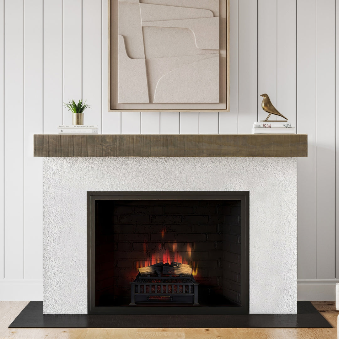 Modern Ember log set with realistic flames in modern shite stucco fireplace surround and wood mantel.