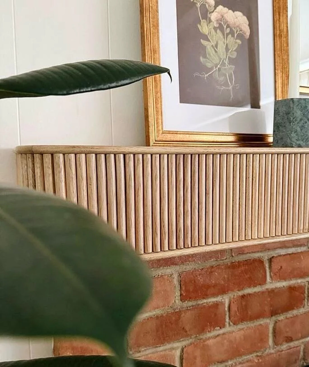 Customer image of white oak mantel shelf on top of brick fireplace mantel surround