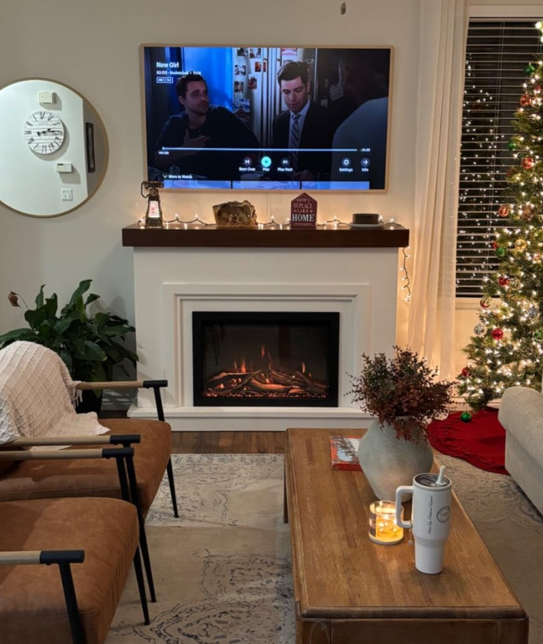 Customer image of electric fireplace with white mantel package and Christmas tree in living room.