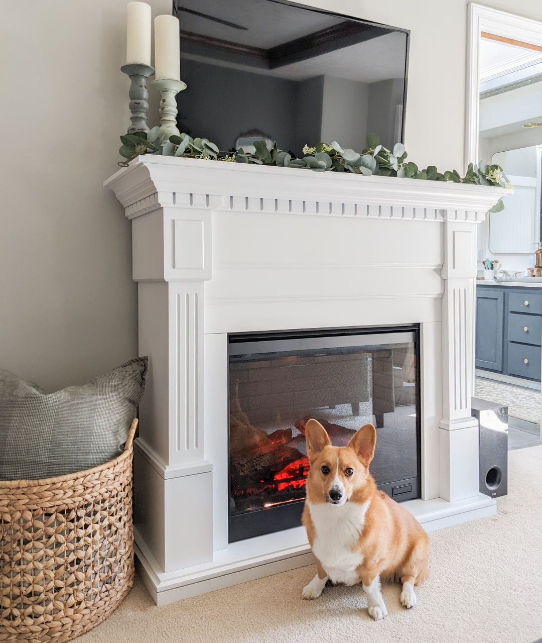 customer image of electric fireplace with white mantel package with dog in bedroom.