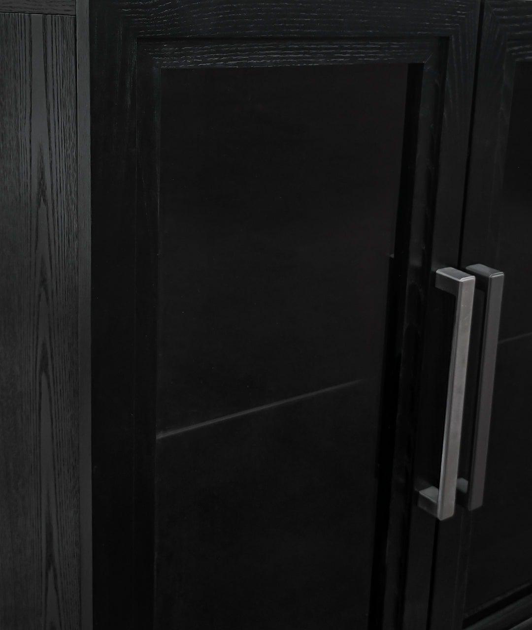 Close-up of Modern Ember black media console cabinet door with brushed silver handles and paneled design