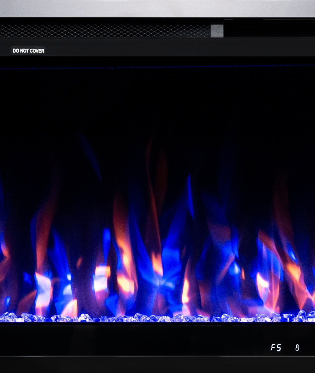 Dynamic flame display with blue, purple, and amber tones over acrylic crystal media in electric fireplace insert
