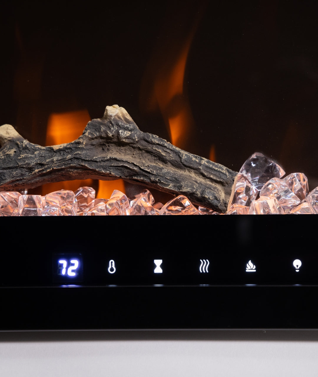 Close-up of Modern Ember electric fireplace display showing log detail, crystal ember bed, and digital controls