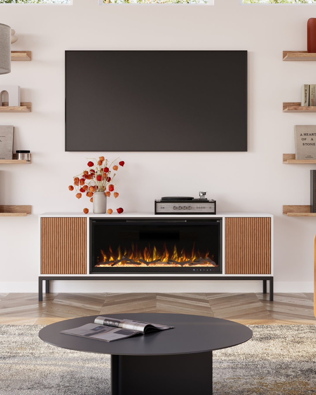 Modern Ember fireplace TV stand styled with record player, wall-mounted screen, and fall floral accents
