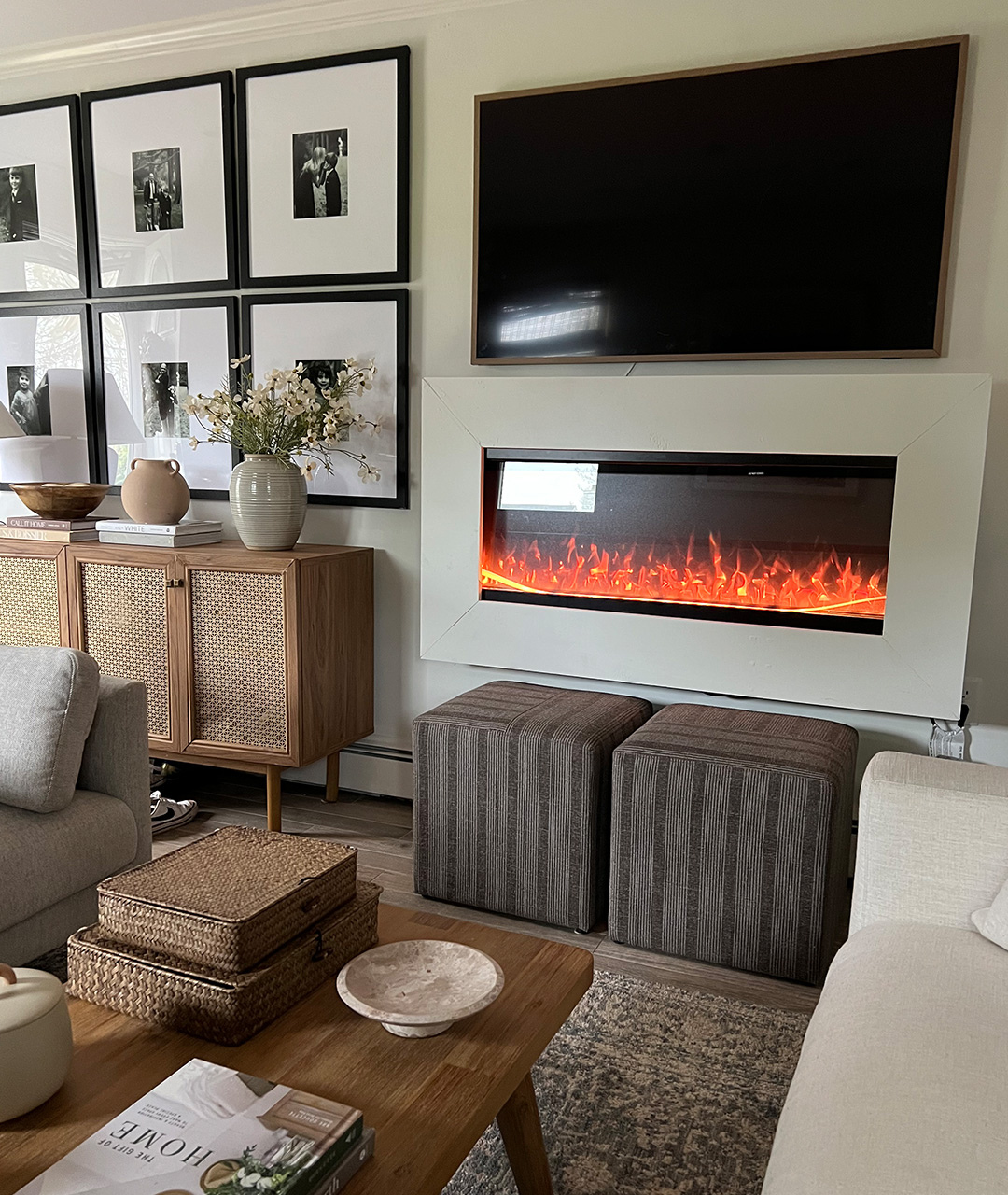 "Modern Ember electric fireplace installed by trade professional in a custom angled wall feature beneath a mounted TV, highlighting expert craftsmanship and seamless integration into a stylish living room.