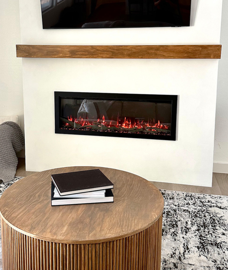 Modern Ember electric fireplace seamlessly installed in a clean, contemporary living room with custom wall build-out and wood mantel—showcasing professional-grade results trusted by trade pros.