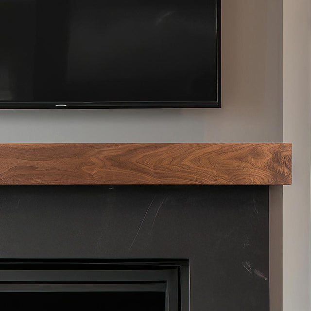 Walnut Creek 72-in Wood Mantel Shelf - Matte Clear Finish mounted above black firebox with TV above.