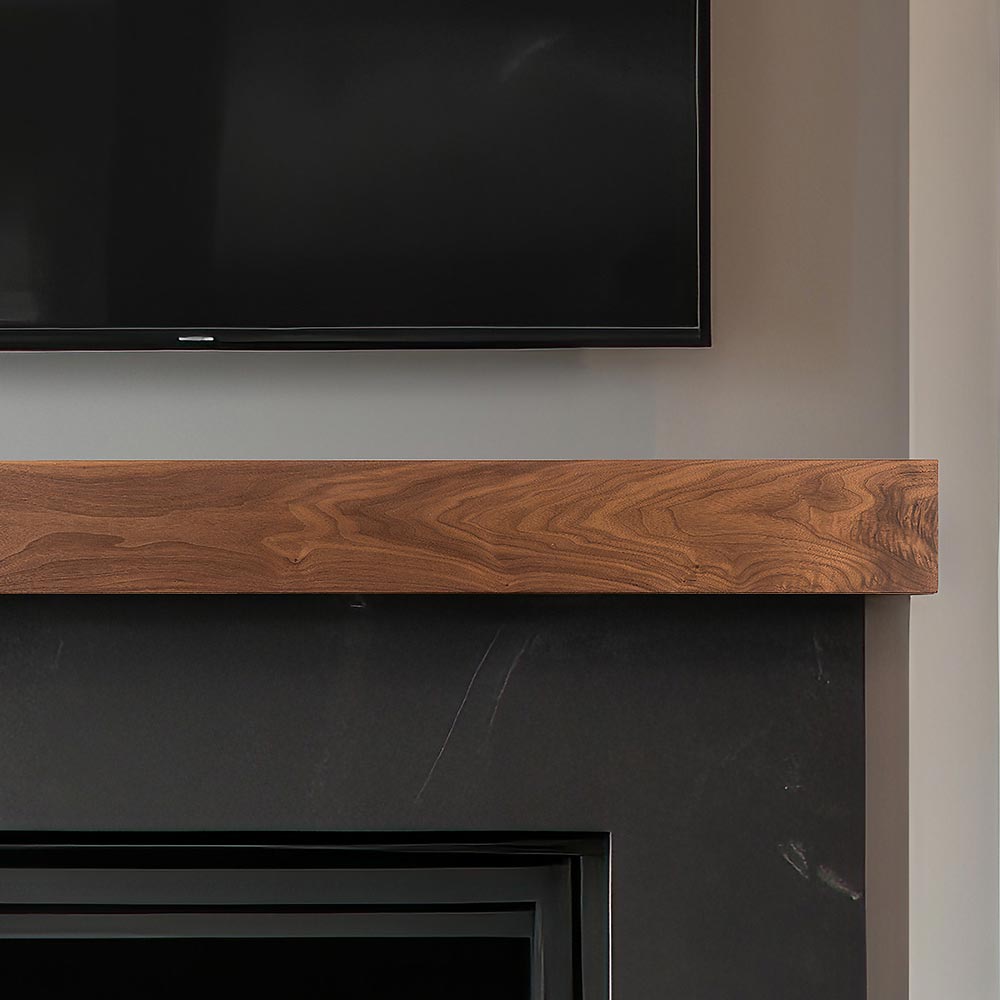 Walnut Creek 72-in Wood Mantel Shelf - Matte Clear Finish mounted above black firebox with TV above.
