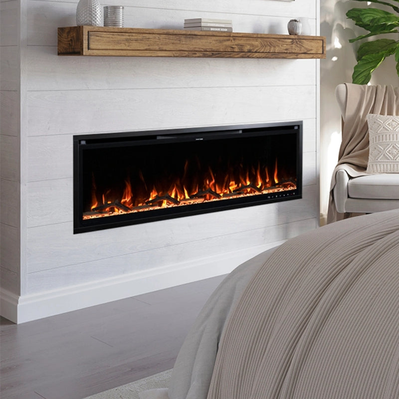 A modern recessed electric fireplace with glowing orange and yellow flames, set into a white shiplap wall above a bed in a styled bedroom.