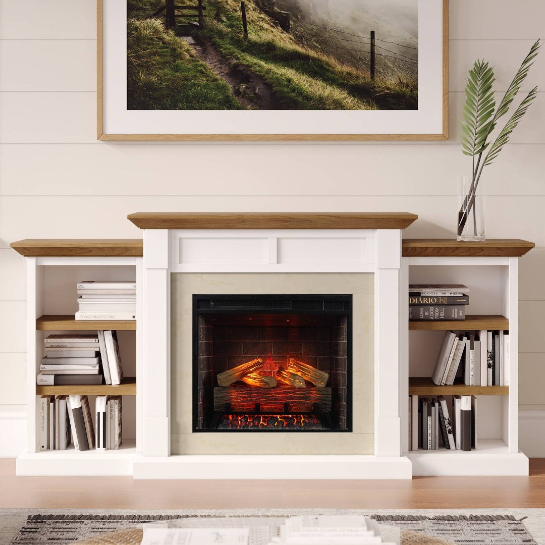 A white fireplace mantel with firebox and built-in shelving unit with a wood-look top and shelves, styled with books and a framed landscape print above on a white shiplap wall.