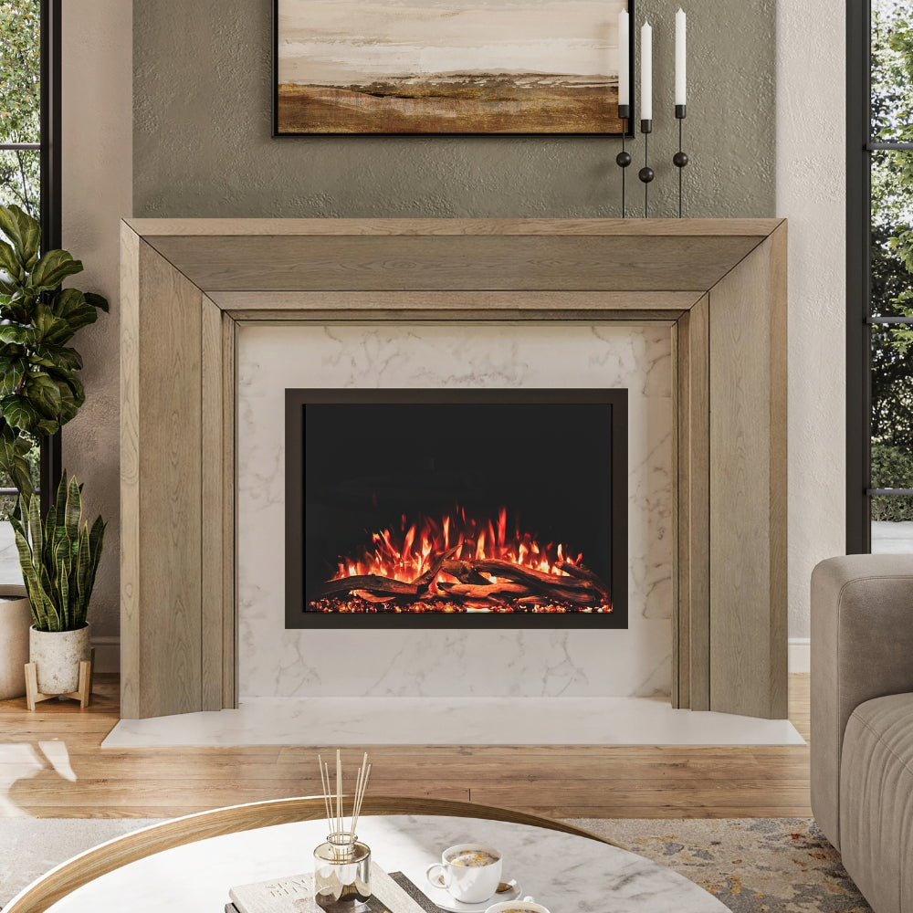 Everly Mantel Surround in blonde wood finish, installed around an electric fireplace, highlighting its clean lines and modern transitional style.