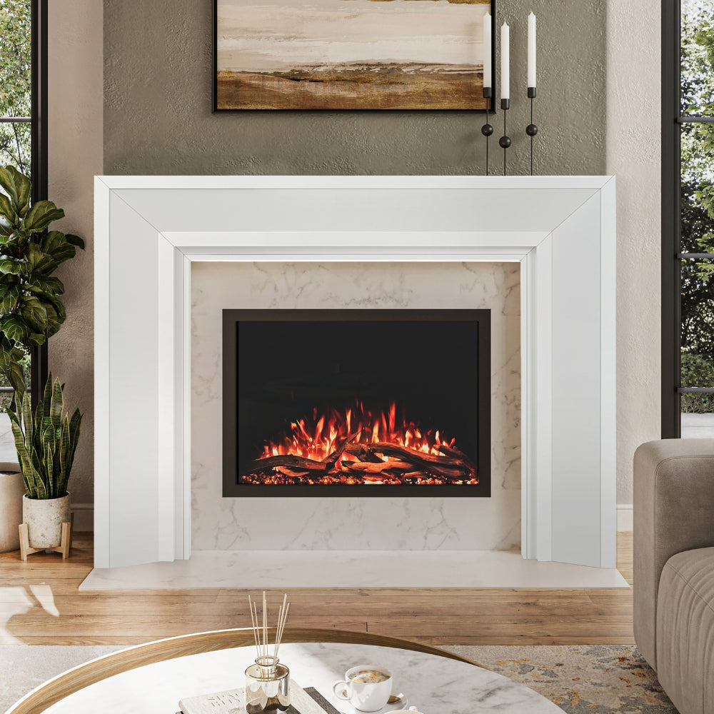 Everly Mantel Surround in white wood finish, installed around an electric fireplace, highlighting its clean lines and modern transitional style.