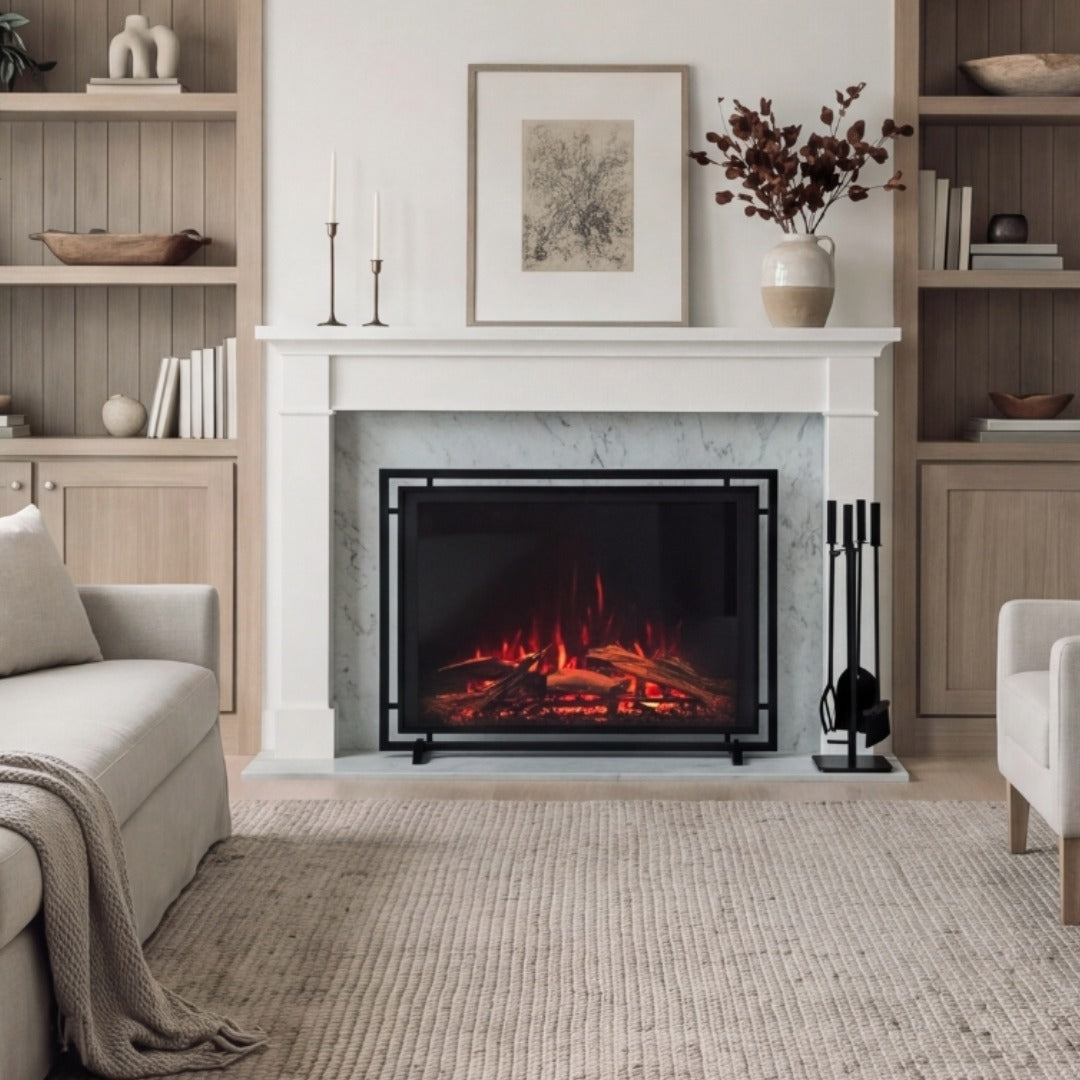 A modern electric fireplace with glowing orange and red faux logs, set within a white marble-look mantel and framed by built-in wood shelving in a styled living room.