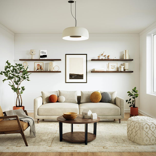 straight on view of Modern living room with a beige sofa accented with Alma 36-in Maple Floating wooden wall shelves in  Umber Stain  decorated with books, ceramics, and artwork, creating a clean and contemporary design.