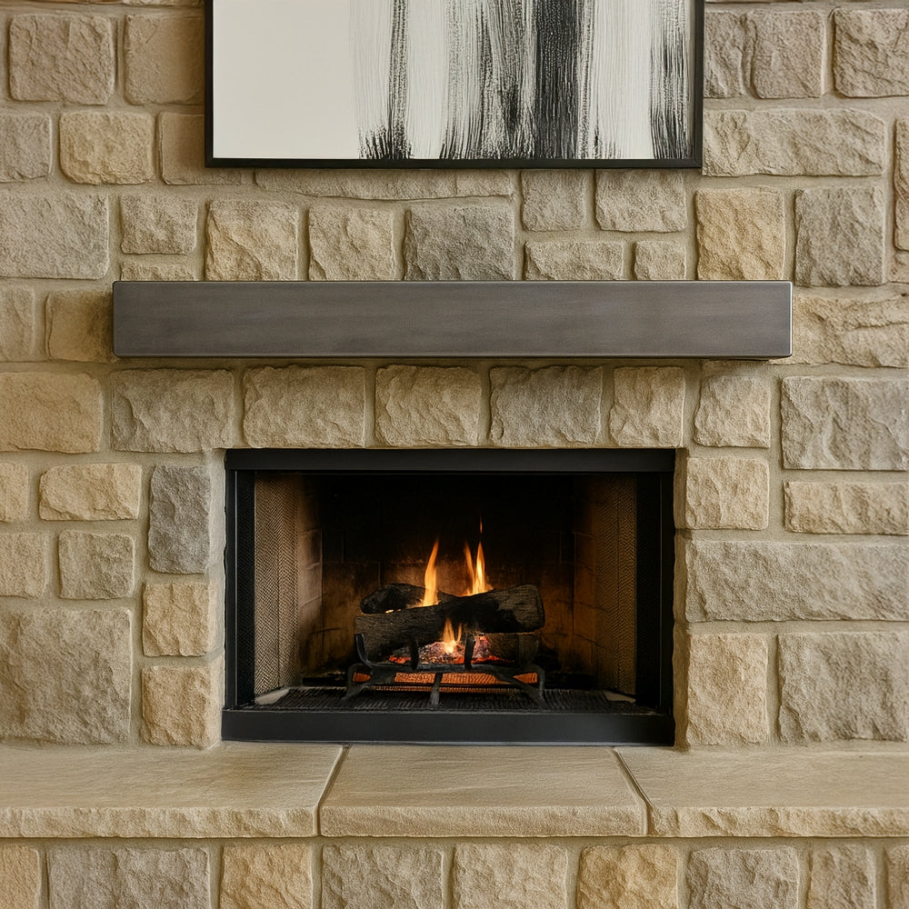 Wide view of a living room fireplace with a fire burning, showcasing the Lustra Metal Mantel Shelf in a silver birch finish mounted above.