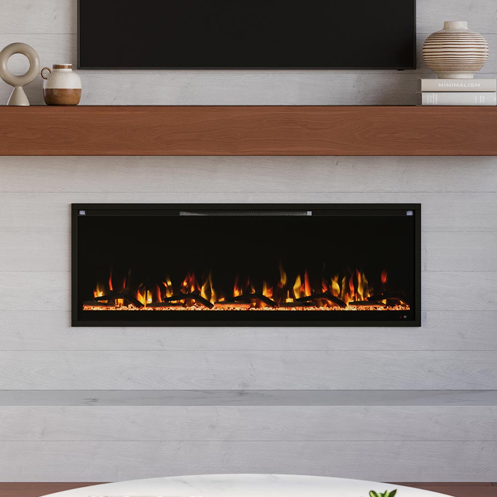 Modern Ember Aerus Slim Linear Electric Fireplace, 50-inch wide model, recessed into a white shiplap wall, showcasing realistic orange and yellow flames over a clear crystal ember bed.