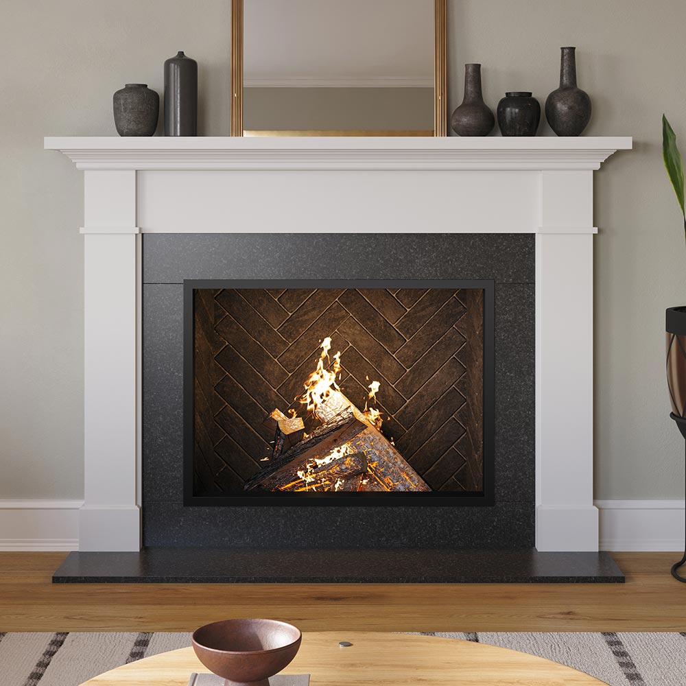 Arden 48x41 Wood Mantel in white painted finish, framing a herringbone firebox with a burning wood fire, styled with modern ceramic vases and a wall mirror for a transitional living room design.