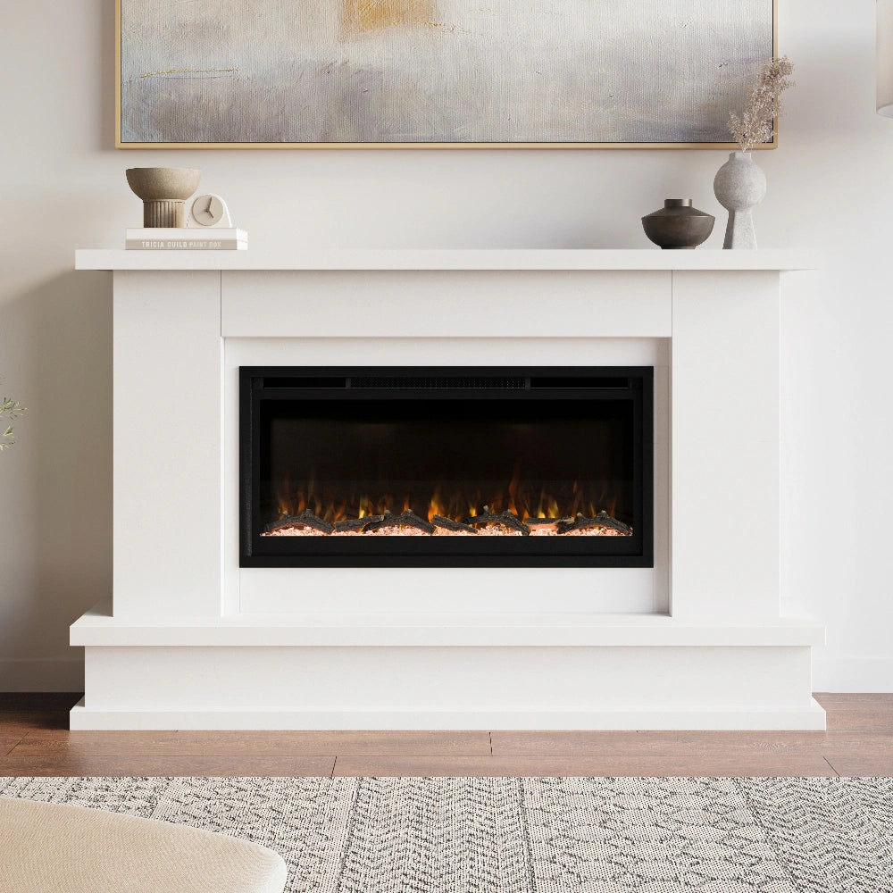 White electric fireplace mantel package with decorative items on a mantel in a living room.