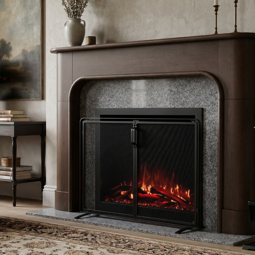A black electric fireplace screen with glass doors stands in front of a dark wood mantel and gray stone surround, with a glowing faux fire visible inside.