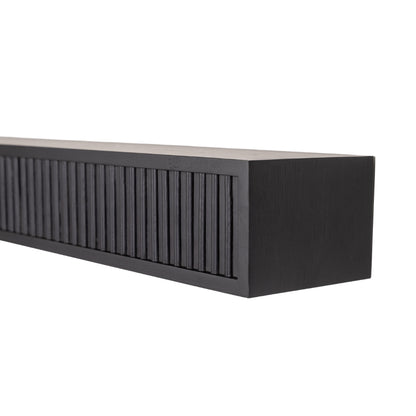Close-up angled view of the black Monti Boxframe fluted floating mantel shelf.