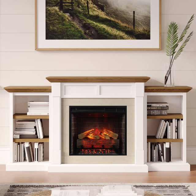 A white fireplace mantel with firebox and built-in shelving unit with a wood-look top and shelves, styled with books and a framed landscape print above on a white shiplap wall.