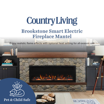 Brookstone Smart Electric Fireplace Mantel by Country Living shown installed in a stone fireplace with a wood mantel, flanked by dark cabinets, in a styled living room setting.