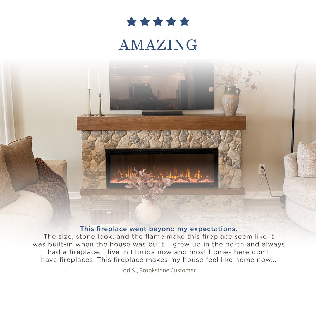 An electric fireplace with a stone surround and wood mantel, shown in a styled living room setting with a customer review text overlay at the bottom and a five-star 'AMAZING' rating banner at the top.