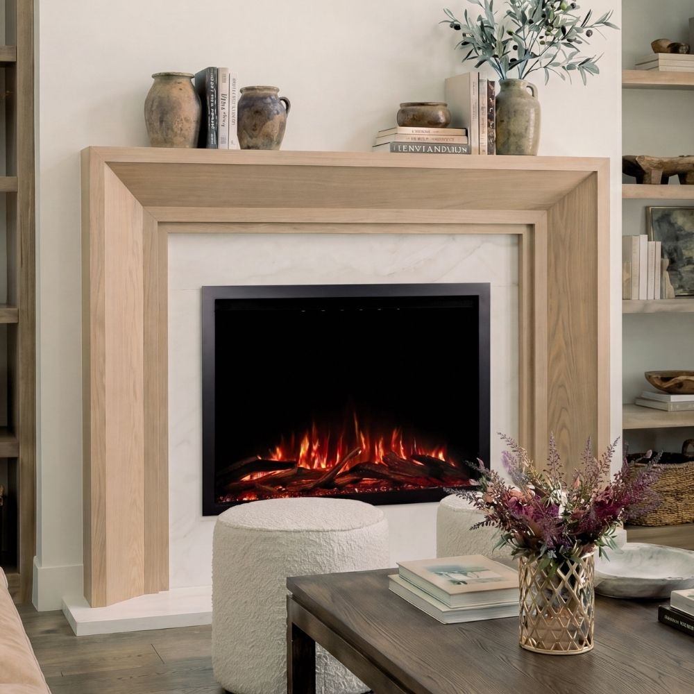 A modern electric fireplace insert with glowing orange and red flames, set within a light wood mantel in a styled living room.