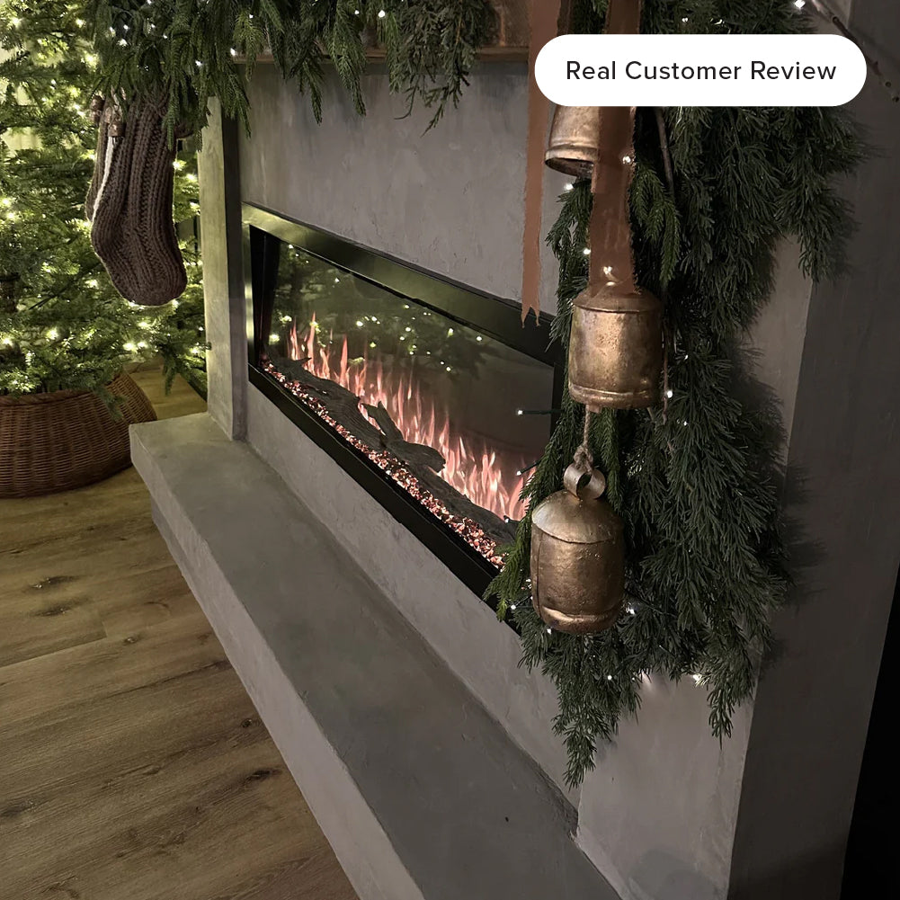 Close-up costumer image of the Highmark fireplace showcasing vibrant red, orange, and blue flame effects over a crystal ember be in living room decorated for the holidays. 