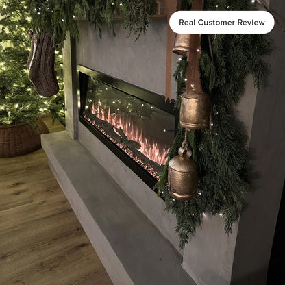 Close-up costumer image of the Highmark fireplace showcasing vibrant red, orange, and blue flame effects over a crystal ember be in living room decorated for the holidays. 